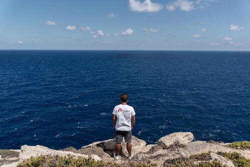 Alessandro Trainito, MSF anesthetist, looks at the sea on the southern coast of Lampedusa. From here, Libya and Tunisia are only a few hundred kilometers away.