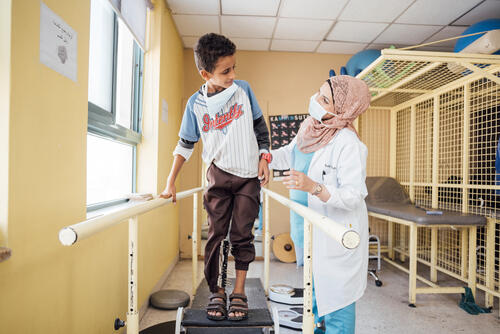 With the support of MSF physiotherapist Rula Marahfeh  Ahmed Darwesch learns how to walk again. The 11 years old boy was injured in an explosion in Yemen.