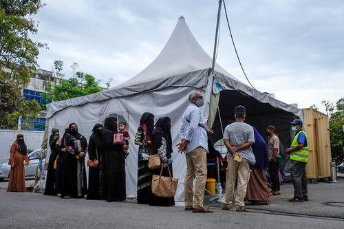 Patients, most of whom are from the Rohingya community, queue up for triaging at the MSF clinic in Butterworth, Penang.