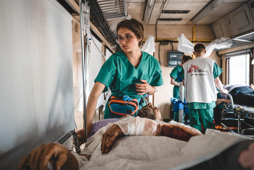 MSF nurse, Anastasia Prudnikova, monitors a war-wounded patient inside the inpatient department of the medical team during a journey from Pokrovsk, in eastern Ukraine, to Lviv in western Ukraine. The journey takes approximately 20 hours.  Since 31 March, we have transported more than 600 patients.