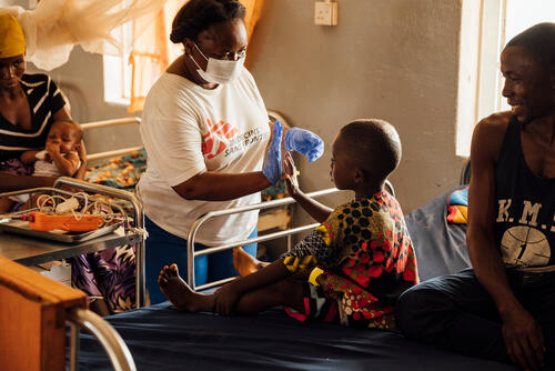 MSF Nursing Team Supervisor Regina Sandy gives a high-five to a recovering patient. The boy was treated in the paediatric wards in the MSF-supported Magburaka District Hospital. 

Regina supervises the nurses in the paediatric wards in the hospital: ICU, Inpatient Therapeutic Feeding, ER and neonatal ward. Regina first joined MSF in Bo during the Ebola epidemic that hit Sierra Leone between 2014 and 2016.
