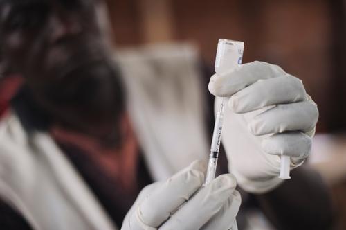 A nurse fills a hyperdermic syringe with live yellow-fever vaccine in a church-cum-school used as a vaccination centre in the village of Kalungu II during an MSF vaccination campaign in Masisi territory in the east of the Democratic Republic of the Congo on August 13, 2014. Kalungu II lies two and a half hours walk from Kishee.