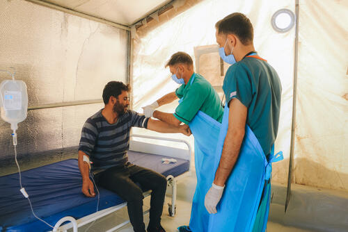 A healthcare worker examining Mohamad Al-Merhi, a Cholera patient in the MSF-supported Cholera Treatment Unit (CTU) in Idlib governorate, northwest Syria.