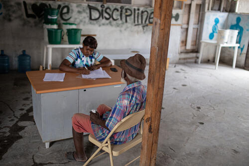 An old man with cholera like symptoms receives oral rehydration solutions to recover from the disease.