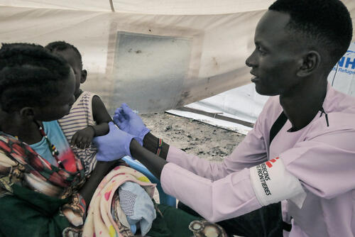 MSF Nurse Gatwech Tuoch immunizes a child against measles at the MSF Mobile Clinic in Bulukat, Upper Nile State South Sudan.