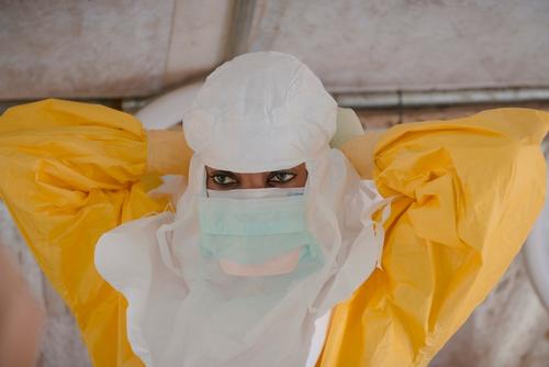 MSF staff dressing in PPE to enter the high risk zone at MSF ETC in Donka, Conakry.