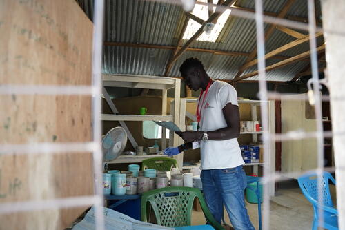 An MSF medicine dispenser Gatluak is packing medicines as per the prescription for the patients at the OPD area of the MSF hospital in Lankien, Jonglei State, South Sudan.