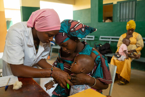In the paediatric ward of the community health centre, nurse Mariam Dembele takes a child's vital signs.