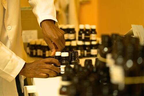 A pharmacy technician packages methadone doses to be delivered to patients in prisons and hospitals. Prison and hospital deliveries ensure continuity of care for them.