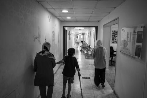 Amman, Jordan. 27 August, 2024.

8 year-old Hazam walks next to her mother Eman and sister Dima on a hallway in MSFÕs Reconstructive Surgery Hospital in Amman, Jordan.

Hazam was severely injured on 10 October, 2023, when the house next to his was bombed. Hazam was on the street when a metal object fell on his leg, injuring him. His eldest brother, Hamza, 14, was killed in the attack, and his sister Dima suffered serious injuries.