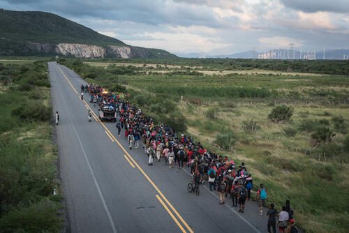 A caravan of migrants escorted by police officers advances along the route between the towns of La Venta and Juchitán, in southern Mexico.