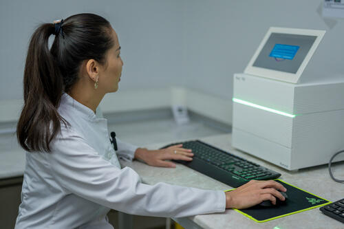 Khalima Mamutova, a state lab microbiologist and former MSF staff next to the Targeted Next-Generation Sequencing (tNGS)   machine in the laboratory in the city of Nukus, the republic of Karakalpakstan in western Uzbekistan. 

This state-of-the-art lab, developed in collaboration with the Ministry of Health and MSF, is equipped with tools like GeneXpert and tNGS for rapid, precise TB diagnostics.