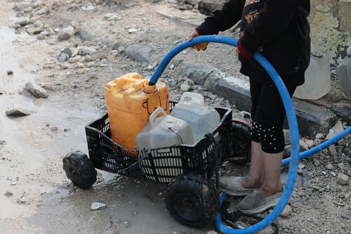 Palestinian child is collecting water in Beit Lahia city, north of Gaza strip, Palestine.