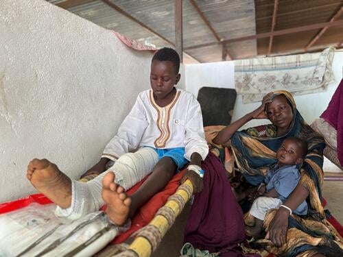 Adil, 12-year-old, next to his mother Nawal and little brother Musa. As many of the children recovering the paediatric ward of Tawila Hospital on that day, Adil is suffering from a bullet injury, as he was shot on his way out of Zamzam camp. 
Out of the 779 patients MSF have treated since April 11th for gunshot wound, 138 were children.