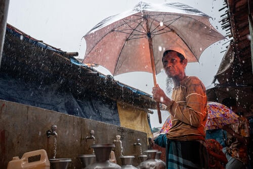 Kutupalong Refugee Camp, Rohingya Response: Ershadullah (60) at an MSF water point in the Kutupalong refugee camp. He fled to Bangladesh in 2017.
