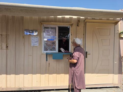 Dost Muhammad receives his medication from the pharmacy at the MSF primary healthcare clinic in Tirah Valley, Khyber Pakhtunkhwa, where, since 2022, MSF has been providing free care to families who have returned after years of displacement due to conflict.