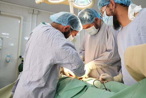 MSF and Ministry of Public Health staff perform surgery in one of three operating theatres at Boost hospital, Lashkar Gah, Helmand Province, Afghanistan. In 2020 teams performed over 4,900 surgical interventions.