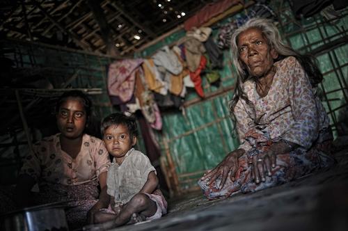 A family in their tent in a refugee camp on the outskirts of Sittwe, February 2, 2013. photo by Kaung Htet