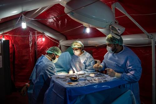 Surgeon Andres Carot, centre, leads an operation to extract a bullet lodged in the abdomen of a patient in the operating theatre of the MSF hospital in Northern Syria, on Thursday, January 31, 2013. 