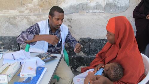 MSF doctor examining IDP child.