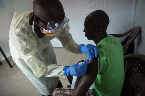 Volunteer Ebola frontline worker receiving the experimental vaccine at the vaccination clinic, inside Donka Hospital compound, Conakry.