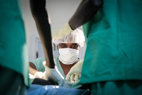 Dr Dida, MSF Surgeon operating a gunshot wounded woman.