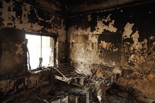 The remains of a bed frame in a room on eastern wing of the main Outpatient Department building.