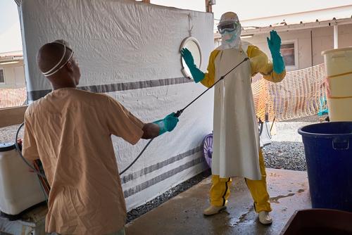 A medical worker is sprayed down after testing a patient for Ebola at the Nongo Ebola Treatment Clinic in Conakry, Guinea on November 26, 2015. 

The clinic is treating the last known Ebola patient in Guinea. A month old baby named Nubia, whose mother died after giving birth on October 27th.
