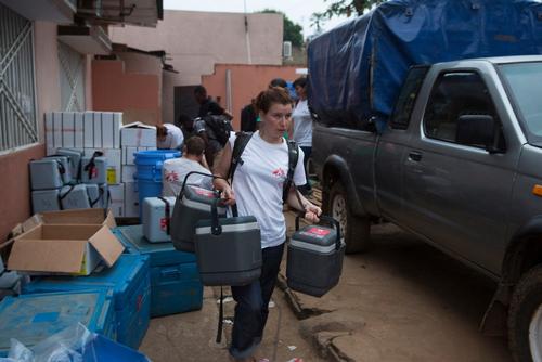A Medecins Sans Frontieres (MSF) staff member carries cold boxes containing yellow fever vaccines on the first day of the vaccination programme in Matadi, DRC.