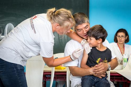 young boy receiving vaccine.