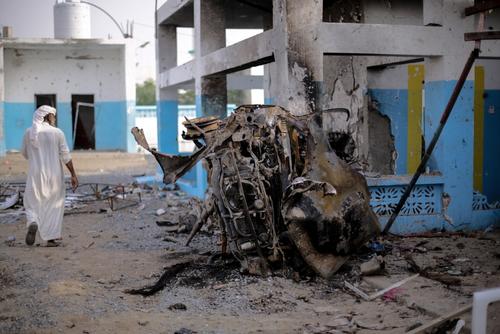 The charred remains of a car smoulders next to the emergency room building of Abs hospital where a 15 August Saudi-led coalition airstrike hit. The bombs all fell with precision within metres of each other suggesting that guided missiles were used in a targeted attack which killed 19 and injured dozens more.
