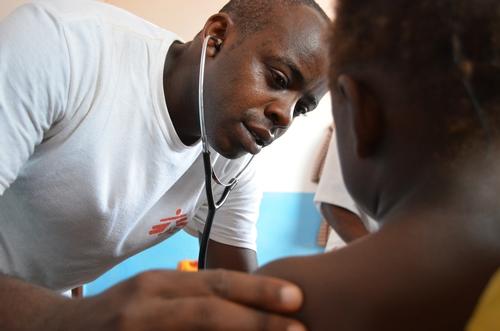Dr Dieudonné Mukunzi listens to a young patient’s breathing during a physical exam in Mbalazime, Bangassou sub-prefecture, Central African Republic.
