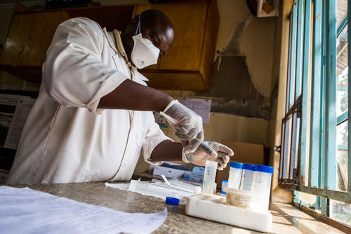 GEORGE ONDIJO IS A LAB TECHNICIAN AT NDIWAH HOSPITAL IN HOMA BAY COUNTY. HE IS IN CHARGE OF SPUTUM COLLECTION FOR TUBERCULOSIS DIAGNOSIS. THE USE OF MASK IS MANDATORY TO AVOID CONTAGION.