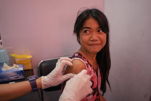A young girl from Tondo, Manila, is seen in a Likhaan clinic for her free HPV vaccination. Likhaan provides reproductive healthcare services for low income families in the Philippines, where there remains a gap in women's awareness of their reproductive rights.