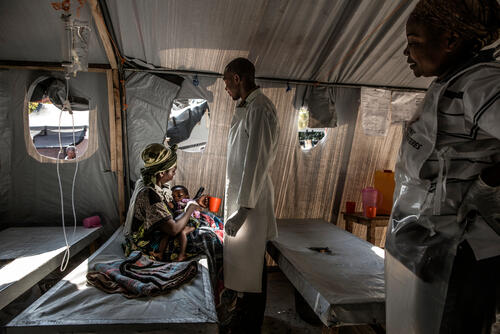MSF staff check on Madeleine Kidolo and her one-year-old son, Mapenzi. They have just arrived at the CTC in Minova.