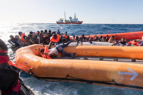 In a nightmarish day on the Mediterranean yesterday, 99 survivors from a sinking rubber boat were rescued by the Aquarius, a search and rescue vessel run by Médecins Sans Frontières (MSF) and SOS MEDITERRANEE, but an unknown number of men, women and children are missing, presumed drowned. Two women are confirmed dead.

“The scene was devastating, with many urgent medical cases in quick succession. They just kept coming, one after another, unconscious and not breathing,” said MSF nurse Aoife Ni Mhurchu. 

Dozens of people were already in the sea when the Aquarius arrived at the scene around 9.30am, and the rubber boat was already deflating. All floating devices were deployed from Aquarius, rafts were launched and the rescue team started pulling people from the sea. 

The MSF medical team on board the Aquarius resuscitated six young children, and one woman. Despite their best efforts they were unable to resuscitate two other women who had drowned. 

“It is absolutely heartbreaking. These women were mothers. We’re now trying to care for their very young children who remain onboard Aquarius” said Ni Mhurchu.

All medical emergencies together with their caretakers were evacuated from Aquarius by an Italian Navy Helicopter to Sfax, Tunisia – a total of sixteen people. This included all six resuscitated children and several women with water on their lungs. The MSF medical team also treated many severe fuel burns, as well as over a dozen mild to moderate hypothermia cases. Many survivors were disorientated and confused as a result of inhaling fuel which had leaked into the rubber boat.
