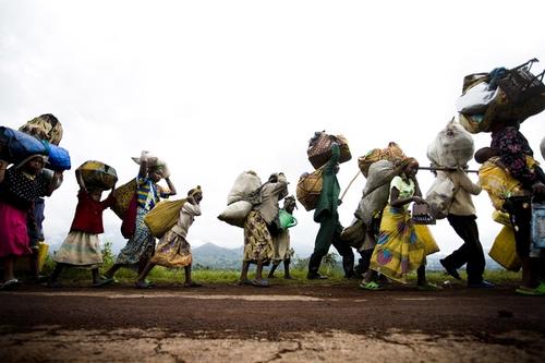 Over 25 000 people carry their belongings as they flee one of the main refugee camps due to fighting on Monday, Oct. 27, 2008 near Kibumba in eastern Congo. Government soldiers are forced to retreat as they are being pushed closer to Goma by rebels of renegade Gen. Laurent Nkunda.