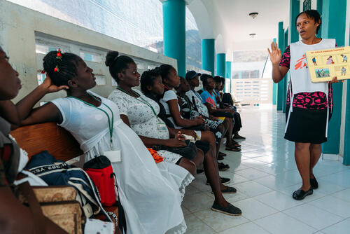 Port-à-Piment. March 2020. Hospital of Port-à-Piment where MSF is providing mother and child care and perform easy deliveries. A health promotor is explaining the health measures for pregnant women. For complicated deliveries, patients are transferred to other hospitals where sometimes the patients are refused, because there is no electricity or because they ask the patients to buy their medicines before being taken care of. The closest hospital is located in Port-Salut, 45 minutes away in taxi-moto. If the patient is refused, the next hospital is 2 hours away from Port-à-Piment. It is a state-run hospital, often refusing patients for the reasons stated above. The next possibility for the patient to be taken care of is the Hospital in Bonne-Fin. It's very difficult to reach, because it is located in a very remote area with no proper roads leading to it. It's also paying. Usually MSF pays for the patients.