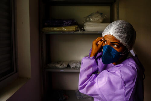 A health worker wears the personal protective equipment before entering the control area of the MSF care center for mild and moderate cases of COVID-19 in São Gabriel da Cachoeira. The facility was specifically adapted to suit local traditions; over 90 percent of the population of São Gabriel da Cachoeira is of indigenous origin. In the care centre, for example, indigenous patients with COVID-19 can remain for the duration of treatment with a carer, something that is not usually allowed in hospitals. Hammocks are available for patients and companions. In addition, traditional medicines used by many people in the region are accepted at the centre and can be taken together with the treatment offered by MSF, as long as their combination does not cause any adverse effects. Shamans, spiritual leaders of indigenous communities, can visit and perform rituals. The only requirement is that they use personal protective equipment to avoid being contaminated while in contact with the patient.