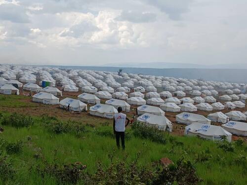 A MSF staff in front of the camp