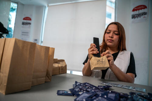 MSF health promoter Kenia Donaire prepares sexual and reproductive health kits to be distributed during the team’s weekly outreach activities in marginalized communities, including LGBTQI+ people and sex workers.