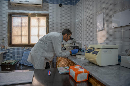 A Directorate of Health (DoH) laboratory technician runs a microscopic test on samples at MSF-supported Darat Izza Primary Healthcare Center. 
MSF concludes three years of support at Darat Izza Primary Health Care Center. Our teams supported the primary healthcare services, including consultations, sexual and reproductive health, emergency care, medicines, laboratory services, health education, and mental health support.