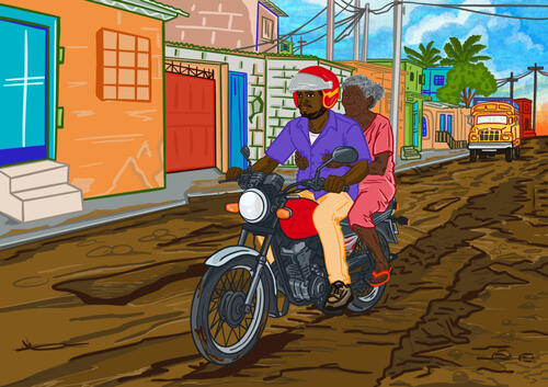 A person on the back of a motorcycle taxi in the streets of Port-au-Prince.