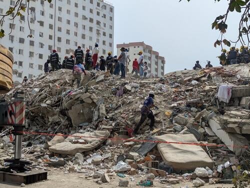 Rescuers search for missing people under the rubble of a collapsed building in Caraballeda, La Guaira, Venezuela, on Tuesday, July 21, 2026. One month after the earthquakes that devastated Venezuela, thousands of people remain missing under the debris.