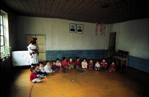 PYONGYANG, NORTH KOREA, ASIA, 25.11.97. Nurse attends young children in an orphanage. Conditions in these hospitals are very poor. The government of North Korea has difficulties in supplying its people with food. The crop was ruined this year. Many young children are suffering and dying of malnutrition.   

 Photo by  Peter van Quaille /MSF-H
horizontal, fc, hospital, orphanage, national, poverty, nurse, staff, child, children, playing, game, orphan
From the Illustrious database.