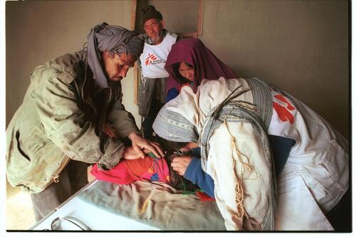 MSF doctor examines the ears of a child. They suffer ear sickness due to the freezing conditions in Yakawlang.